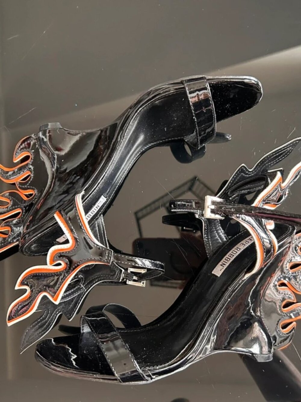 Black patent leather sandals with orange flame design